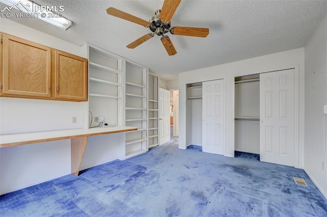 2609 Freedom Hts, Colorado Springs, CO 80904 - unfurnished bedroom with carpet floors, a textured ceiling, multiple closets, a ceiling fan, and baseboards
