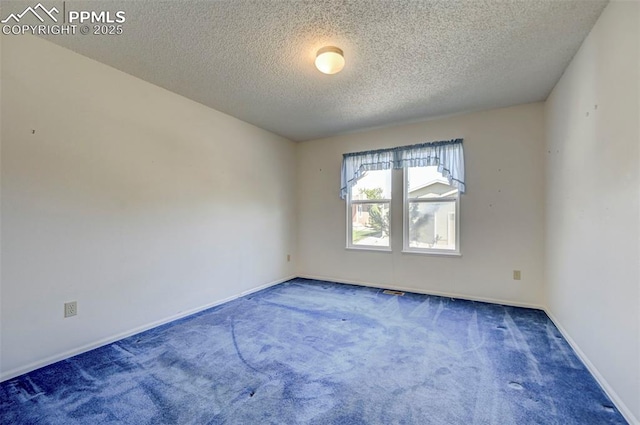 2609 Freedom Hts, Colorado Springs, CO 80904 - empty room with a textured ceiling, carpet flooring, and baseboards
