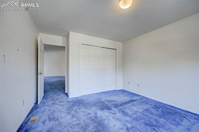 2609 Freedom Hts, Colorado Springs, CO 80904 - unfurnished bedroom with carpet, a textured ceiling, a closet, and baseboards