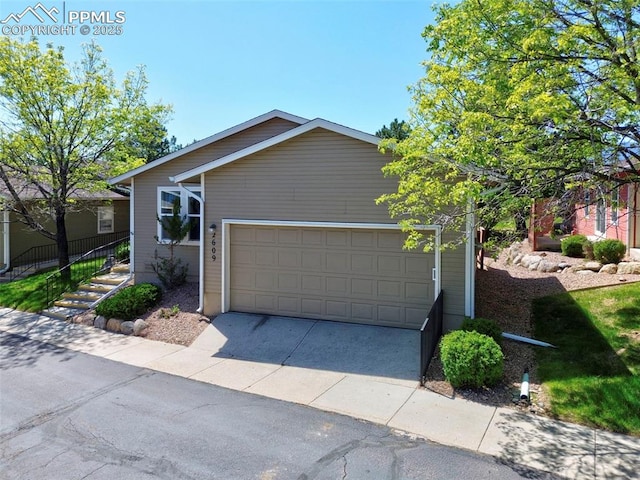 2609 Freedom Hts, Colorado Springs, CO 80904 - view of front facade with concrete driveway and an attached garage