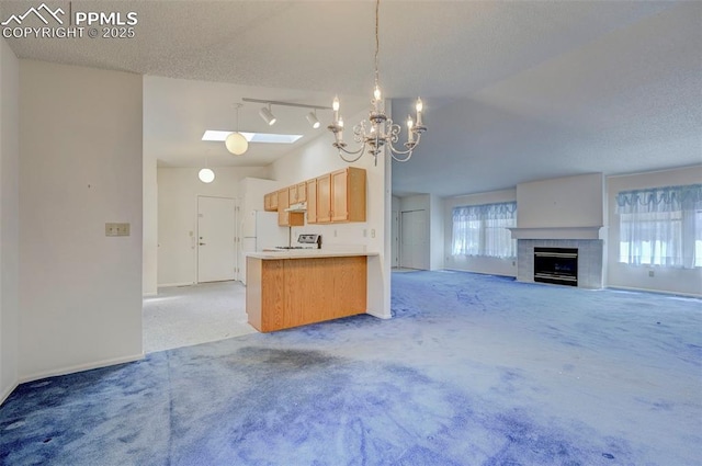 2609 Freedom Hts, Colorado Springs, CO 80904 - kitchen featuring light colored carpet, open floor plan, a chandelier, freestanding refrigerator, and a textured ceiling