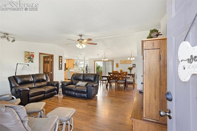 9180 S Rush Rd, Rush, CO 80833 - living room featuring wood finished floors, a ceiling fan, and a chandelier