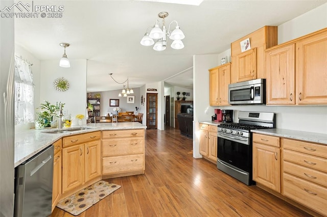 9180 S Rush Rd, Rush, CO 80833 - kitchen with appliances with stainless steel finishes, a chandelier, light brown cabinetry, a sink, and light wood-style floors