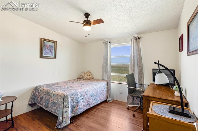 9180 S Rush Rd, Rush, CO 80833 - bedroom featuring wood finished floors, a textured ceiling, and ceiling fan