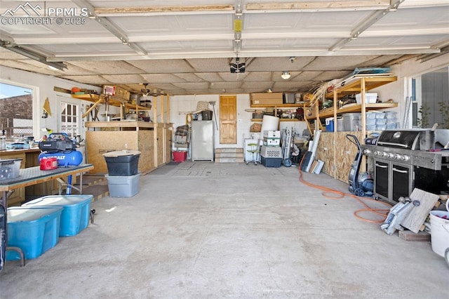 9180 S Rush Rd, Rush, CO 80833 - garage featuring a garage door opener and a workshop area