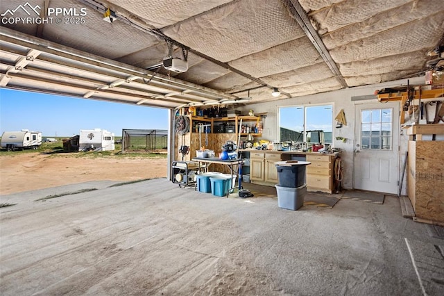 9180 S Rush Rd, Rush, CO 80833 - garage with a workshop area and a garage door opener