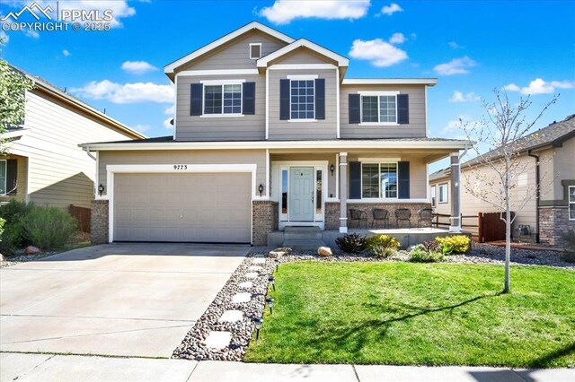 9773 Beryl Dr, Peyton, CO 80831 - view of front of property with concrete driveway, a porch, a front lawn, a garage, and brick siding