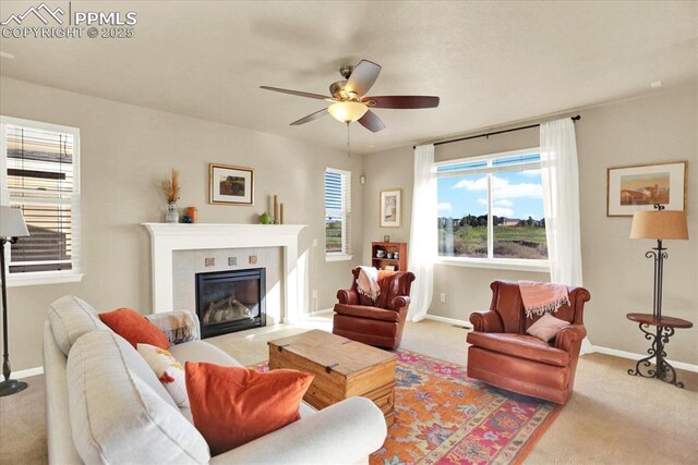 9773 Beryl Dr, Peyton, CO 80831 - carpeted living room with ceiling fan, baseboards, and a fireplace