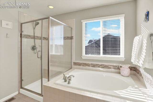 9773 Beryl Dr, Peyton, CO 80831 - full bathroom featuring a bath, a shower stall, and tile patterned flooring
