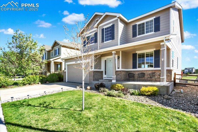 9773 Beryl Dr, Peyton, CO 80831 - view of front of property featuring brick siding, covered porch, driveway, and a front yard