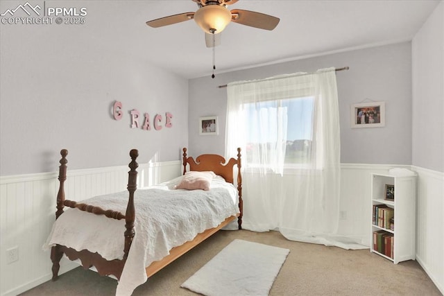 9773 Beryl Dr, Peyton, CO 80831 - carpeted bedroom with a wainscoted wall and ceiling fan