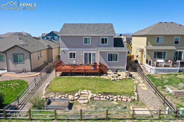 9773 Beryl Dr, Peyton, CO 80831 - rear view of property with a wooden deck, a vegetable garden, and a residential view