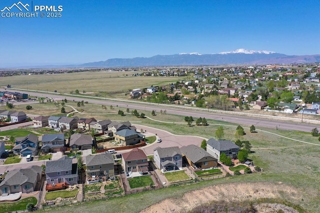 9773 Beryl Dr, Peyton, CO 80831 - aerial view of property's location with a mountainous background and nearby suburban area