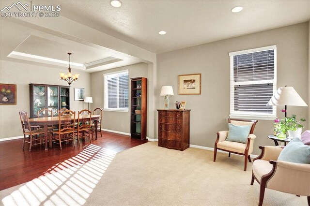 9773 Beryl Dr, Peyton, CO 80831 - dining room with a chandelier, baseboards, a tray ceiling, recessed lighting, and wood finished floors