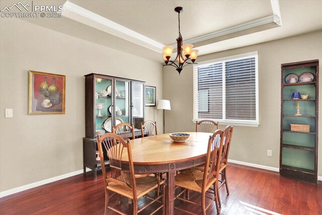 9773 Beryl Dr, Peyton, CO 80831 - dining room featuring a tray ceiling, a chandelier, crown molding, wood-type flooring, and baseboards