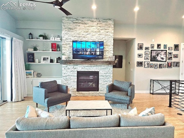 4017 Notch Trl, Colorado Springs, CO 80924 - living room with a fireplace, a ceiling fan, wood finished floors, and baseboards