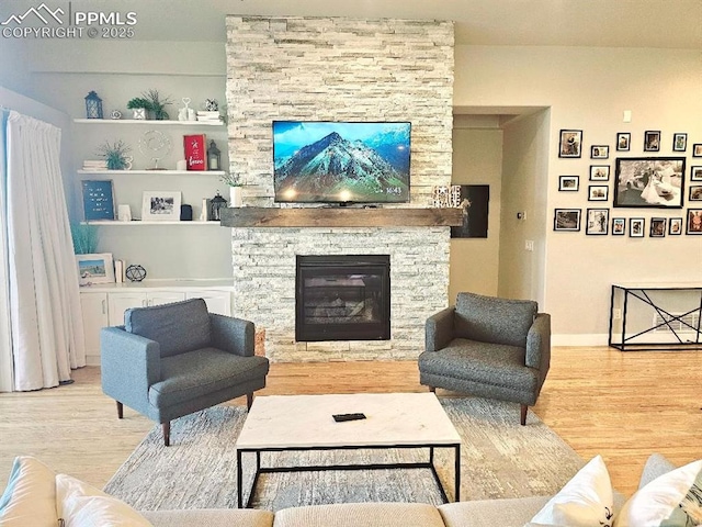 4017 Notch Trl, Colorado Springs, CO 80924 - living area featuring wood finished floors, a fireplace, and baseboards