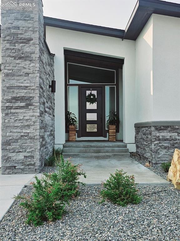 4017 Notch Trl, Colorado Springs, CO 80924 - doorway to property featuring stucco siding and stone siding