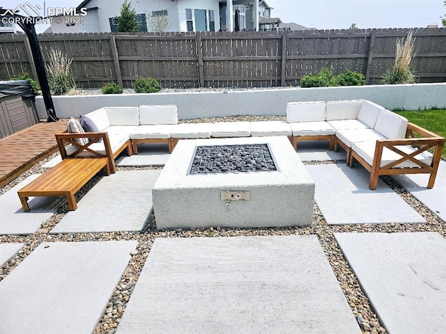 4017 Notch Trl, Colorado Springs, CO 80924 - fenced backyard featuring an outdoor living space with a fire pit and a patio