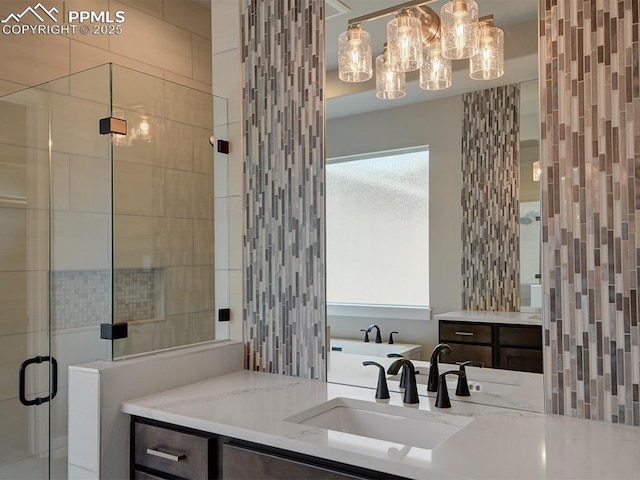 4017 Notch Trl, Colorado Springs, CO 80924 - full bath featuring vanity, a shower stall, plenty of natural light, and a chandelier