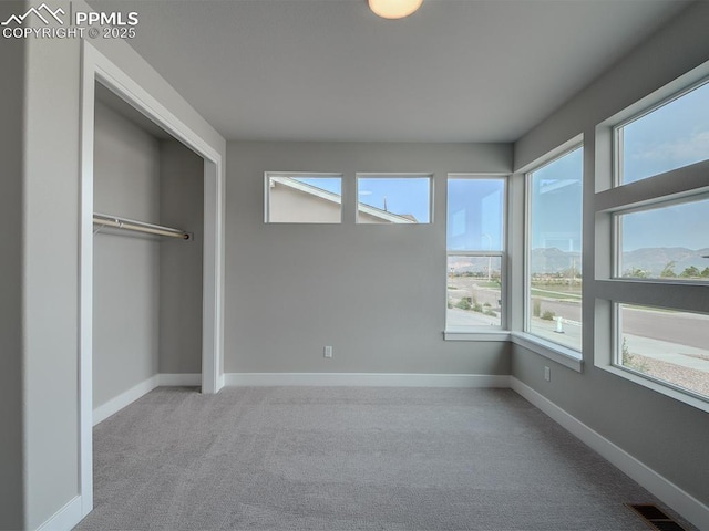4017 Notch Trl, Colorado Springs, CO 80924 - unfurnished bedroom featuring multiple windows, carpet flooring, a closet, and baseboards
