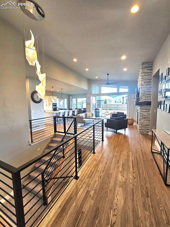 4017 Notch Trl, Colorado Springs, CO 80924 - hall with wood finished floors, an upstairs landing, and recessed lighting