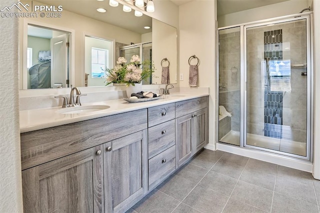 10811 Raylan Way, Falcon, CO 80831 - bathroom featuring double vanity, a shower stall, and tile patterned flooring