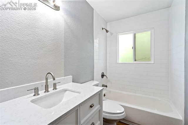 1210 Westend Ave, Colorado Springs, CO 80904 - full bathroom with a textured wall, toilet, vanity, and shower / tub combination