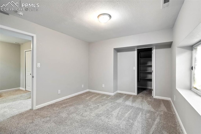 1210 Westend Ave, Colorado Springs, CO 80904 - unfurnished bedroom with carpet floors, a textured ceiling, a closet, and baseboards