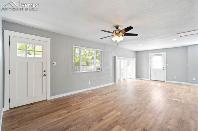 1210 Westend Ave, Colorado Springs, CO 80904 - foyer featuring wood finished floors, plenty of natural light, ceiling fan, baseboards, and a textured ceiling