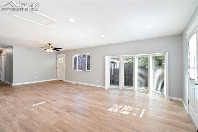 1210 Westend Ave, Colorado Springs, CO 80904 - unfurnished living room featuring healthy amount of natural light, baseboards, light wood-style floors, attic access, and recessed lighting