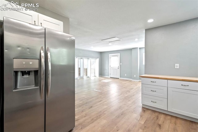 1210 Westend Ave, Colorado Springs, CO 80904 - kitchen featuring stainless steel refrigerator with ice dispenser, wood counters, open floor plan, light wood-type flooring, and white cabinets