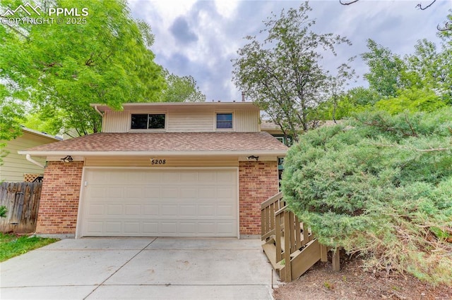 5208 Pinon Valley Rd, Colorado Springs, CO 80919 - view of front of house featuring brick siding, driveway, and a shingled roof