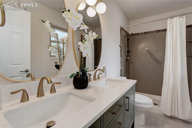 5208 Pinon Valley Rd, Colorado Springs, CO 80919 - bathroom with toilet, a shower with shower curtain, double vanity, and wood finished floors