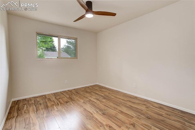 5208 Pinon Valley Rd, Colorado Springs, CO 80919 - empty room with wood finished floors, ceiling fan, and baseboards