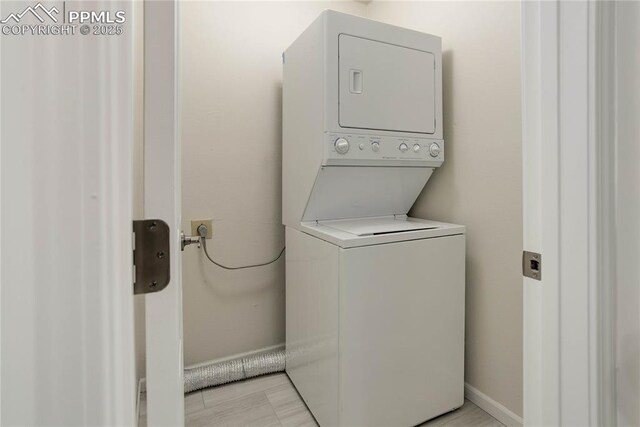 5208 Pinon Valley Rd, Colorado Springs, CO 80919 - laundry area with estacked washer and dryer and baseboards