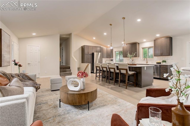 5208 Pinon Valley Rd, Colorado Springs, CO 80919 - living area with light wood-type flooring, recessed lighting, stairway, and vaulted ceiling