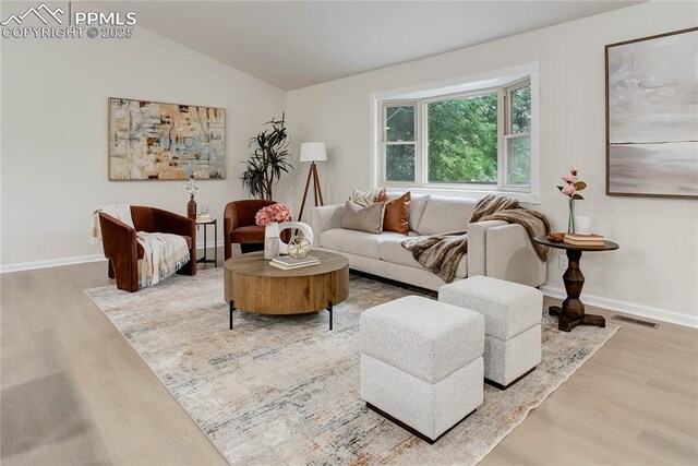 5208 Pinon Valley Rd, Colorado Springs, CO 80919 - living room with wood finished floors, lofted ceiling, and baseboards