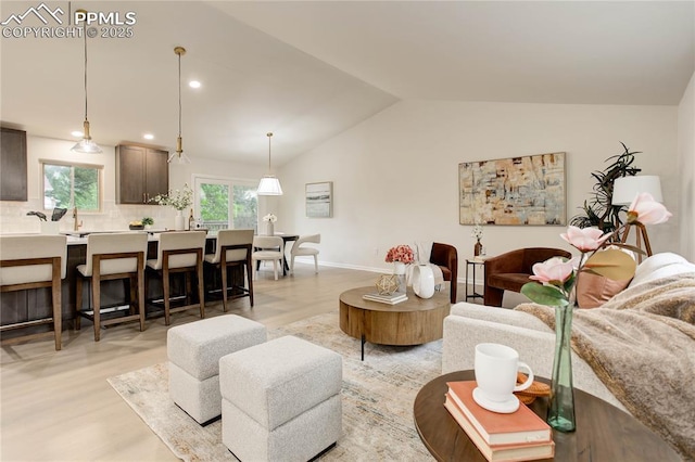 5208 Pinon Valley Rd, Colorado Springs, CO 80919 - living room with lofted ceiling, light wood-style floors, recessed lighting, and baseboards