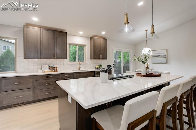 5208 Pinon Valley Rd, Colorado Springs, CO 80919 - kitchen with a sink, tasteful backsplash, dark brown cabinetry, plenty of natural light, and recessed lighting