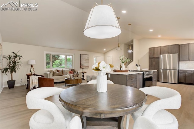 5208 Pinon Valley Rd, Colorado Springs, CO 80919 - dining space with lofted ceiling, light wood-style flooring, recessed lighting, and baseboards
