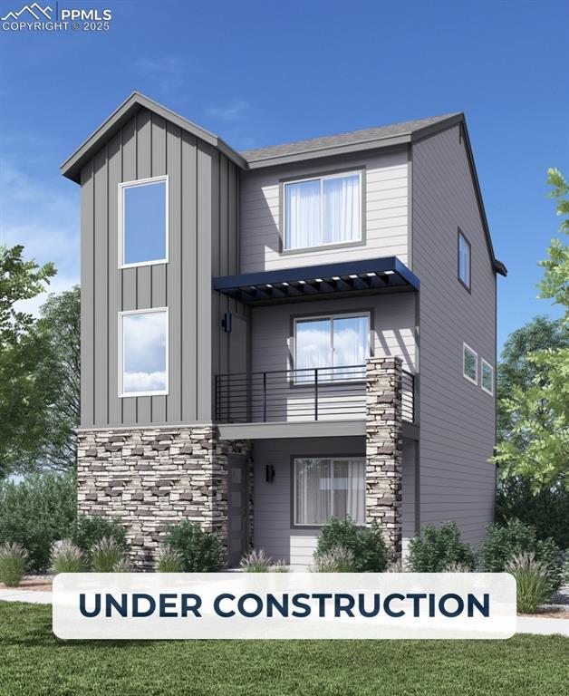 10787 Spalding Vw, Colorado Springs, CO 80908 - view of front of home featuring a balcony, stone siding, and board and batten siding