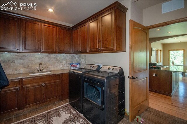 797 Forest View Way, Monument, CO 80132 - laundry area featuring washing machine and clothes dryer, wood finished floors, cabinet space, and recessed lighting