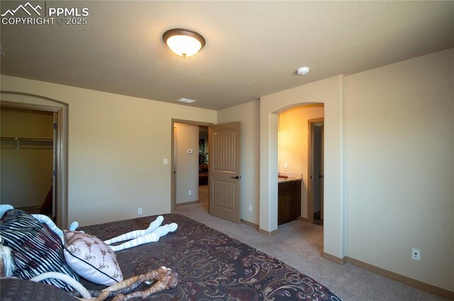 797 Forest View Way, Monument, CO 80132 - bedroom with arched walkways, light colored carpet, baseboards, and a closet