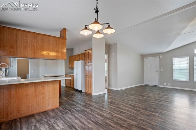 20150 Enoch Rd, Colorado Springs, CO 80930 - kitchen featuring freestanding refrigerator, brown cabinetry, lofted ceiling, dark wood finished floors, and light countertops
