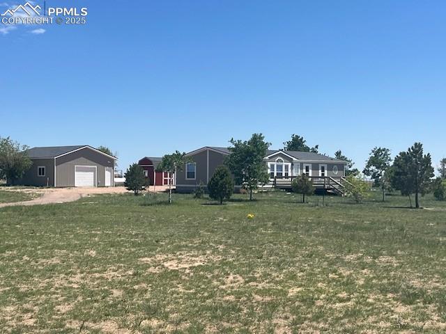 20150 Enoch Rd, Colorado Springs, CO 80930 - view of grassy yard with a detached garage