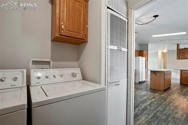 20150 Enoch Rd, Colorado Springs, CO 80930 - laundry area featuring cabinet space, washer and clothes dryer, dark wood-type flooring, and a heating unit