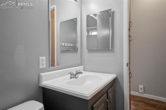 20150 Enoch Rd, Colorado Springs, CO 80930 - half bath with vanity, toilet, wood finished floors, and baseboards