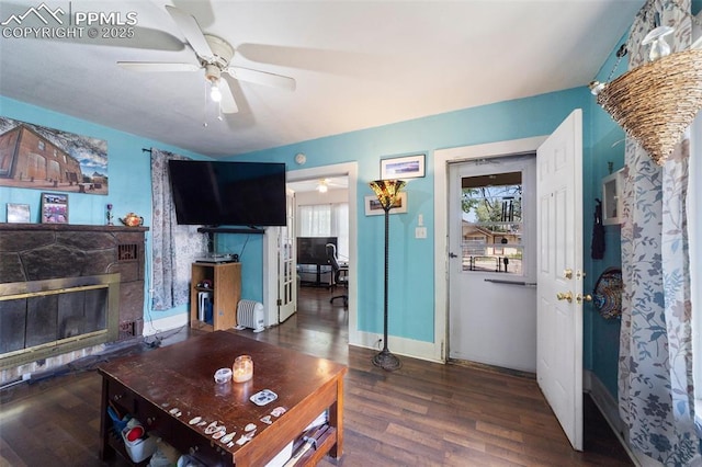 1416 S Wahsatch Ave, Colorado Springs, CO 80905 - living room with wood finished floors, a ceiling fan, a glass covered fireplace, and baseboards