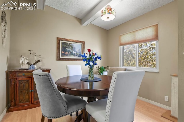 1018 Fontmore Rd Unit D, Colorado Springs, CO 80904 - dining area with light wood finished floors, baseboards, beamed ceiling, and a textured ceiling